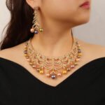 Wholesale Arch Pearl Set featuring a CZ arched leaf bib necklace with dangling colorful shell pearls on gold plated copper from JuneJewelry.com.