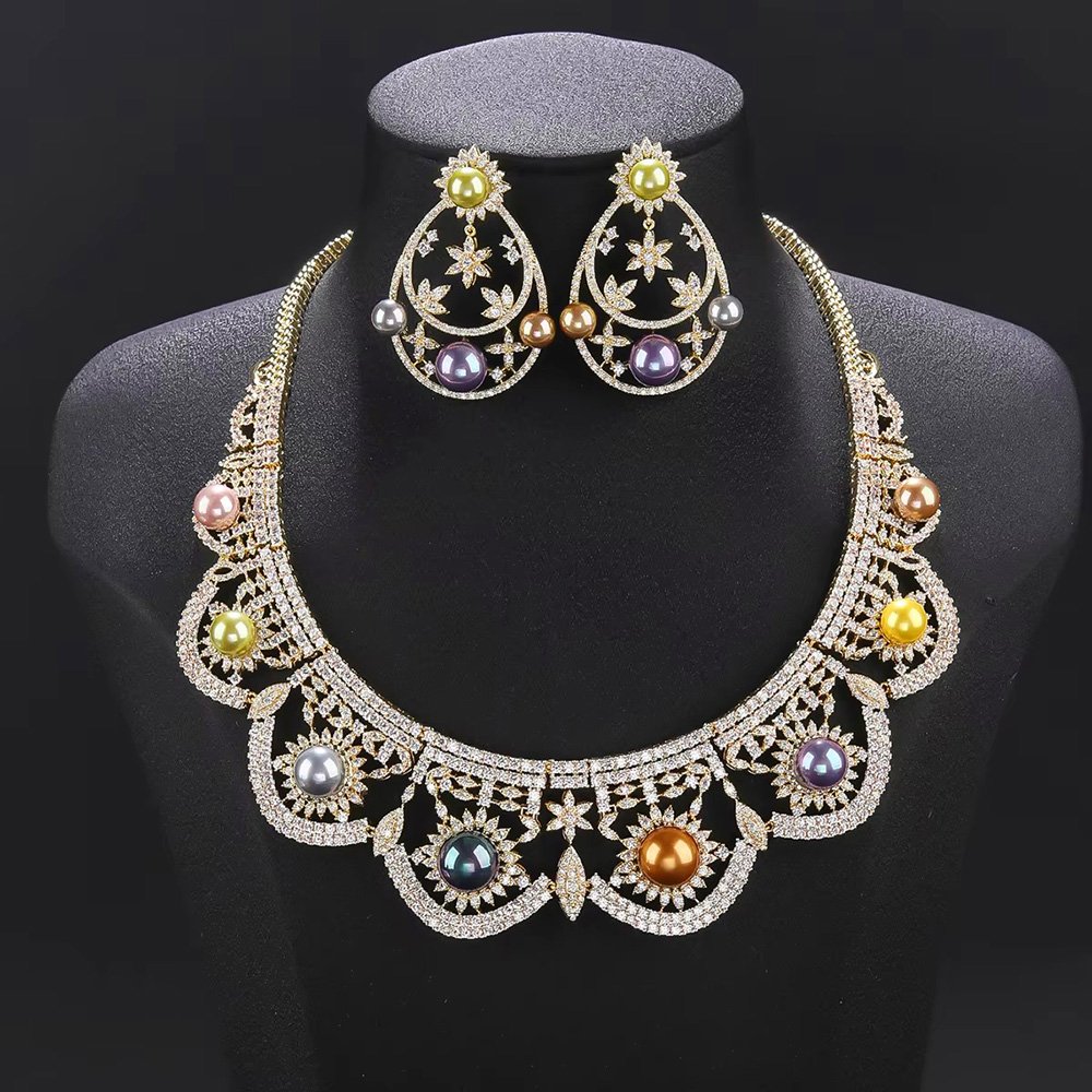 Wholesale Scallop Pearl Set featuring CZ scalloped lace arches with colorful shell pearls on gold plated copper from JuneJewelry.com.