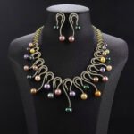 Wholesale Swirl Pearl Set featuring CZ micro paved S-curve links with dangling colorful shell pearls on gold plated copper from JuneJewelry.com.