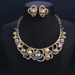 Wholesale Heart Pearl Set featuring CZ paved heart motifs cradling colorful shell pearls on gold plated copper from JuneJewelry.com.