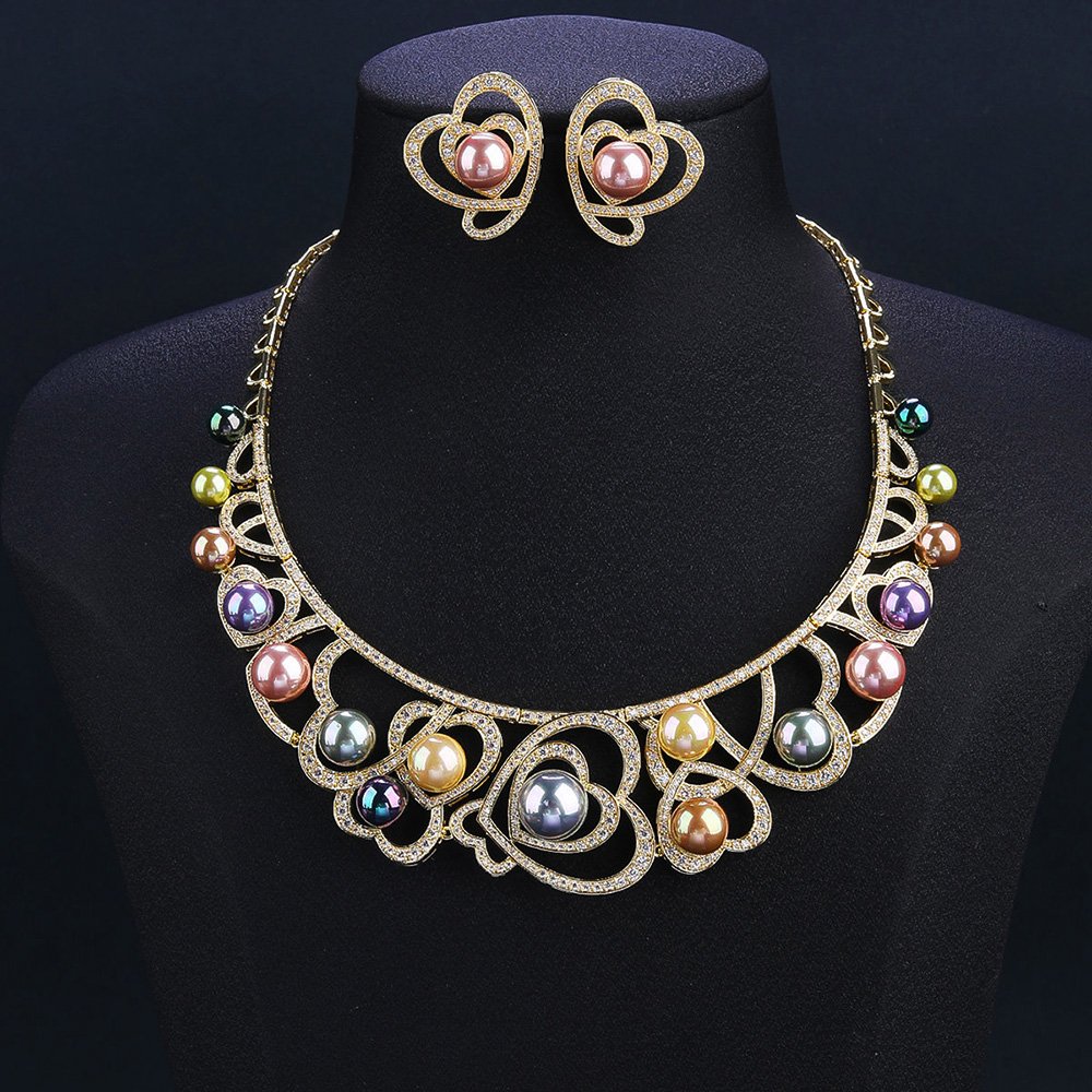 Wholesale Heart Pearl Set featuring CZ paved heart motifs cradling colorful shell pearls on gold plated copper from JuneJewelry.com.