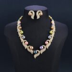Wholesale Curve Pearl Set featuring CZ paved curl motifs cradling colorful shell pearls on gold plated copper from JuneJewelry.com.