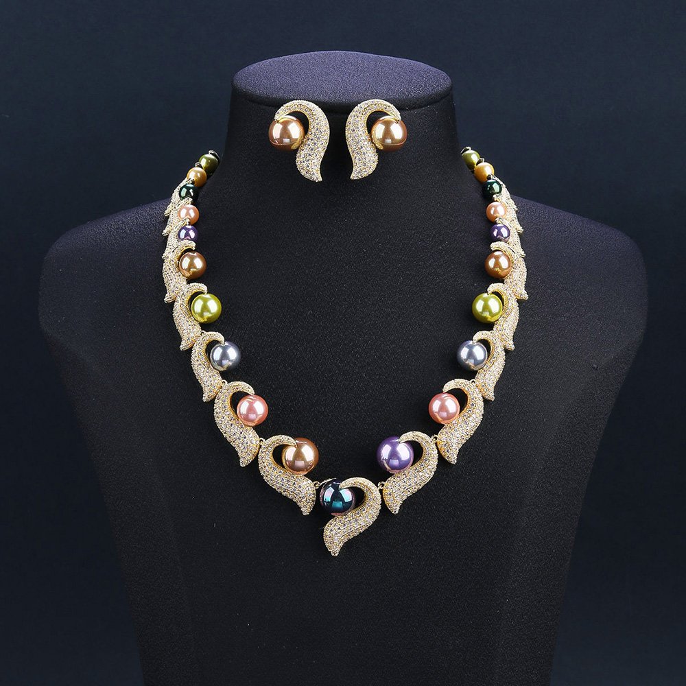 Wholesale Curve Pearl Set featuring CZ paved curl motifs cradling colorful shell pearls on gold plated copper from JuneJewelry.com.