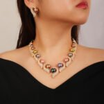 Wholesale Curve Pearl Set featuring CZ paved curl motifs cradling colorful shell pearls on gold plated copper from JuneJewelry.com.
