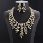 Wholesale Cascade Pearl Set featuring a CZ vine fringe collar with dangling colorful shell pearls on gold plated copper from JuneJewelry.com.