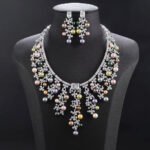 Wholesale Cascade Pearl Set featuring a CZ vine fringe collar with dangling colorful shell pearls on gold plated copper from JuneJewelry.com.