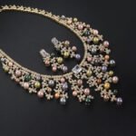 Wholesale Cascade Pearl Set featuring a CZ vine fringe collar with dangling colorful shell pearls on gold plated copper from JuneJewelry.com.