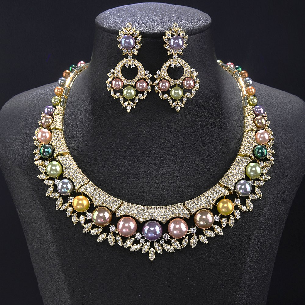 Wholesale Shield Pearl Set featuring CZ micro paved arched plates with colorful shell pearls and marquise leaves on gold plated copper from JuneJewelry.com.