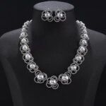 Wholesale Petal Pearl Set featuring CZ micro paved flower motifs with colorful shell pearls on gold plated copper from JuneJewelry.com.