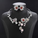 Wholesale Blossom Pearl Set featuring CZ paved cherry blossom branches with red zircons and shell pearls on gold plated copper from JuneJewelry.com.