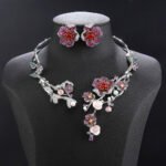 Wholesale Blossom Pearl Set featuring CZ paved cherry blossom branches with red zircons and shell pearls on gold plated copper from JuneJewelry.com.
