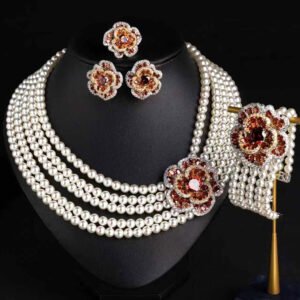 Wholesale Tiered Pearl Set featuring multi strand white shell pearls and CZ orange flower clasps on gold plated copper from JuneJewelry.com.