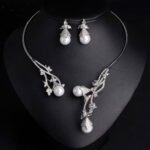 Wholesale Open Pearl Set featuring CZ micro paved branches with champagne shell pearls on gold plated copper from JuneJewelry.com.
