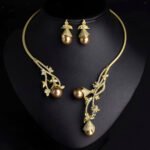 Wholesale Open Pearl Set featuring CZ micro paved branches with champagne shell pearls on gold plated copper from JuneJewelry.com.