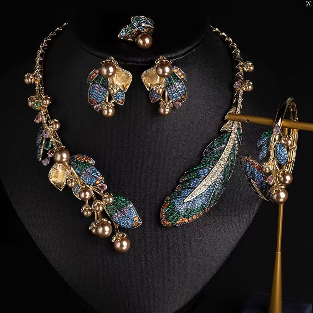 Wholesale Feather Pearl Set featuring colorful CZ paved feathers and champagne shell pearls on gold plated copper from JuneJewelry.com.