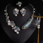 Wholesale Feather Pearl Set featuring colorful CZ paved feathers and champagne shell pearls on gold plated copper from JuneJewelry.com.
