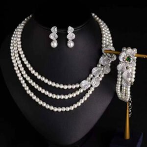 Wholesale Wave Pearl Set featuring multi strand white shell pearls with CZ paved wave flower clasps on gold plated copper from JuneJewelry.com.