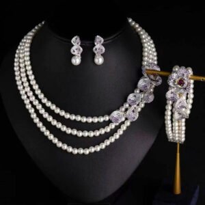 Wholesale Wave Pearl Set featuring multi strand white shell pearls with CZ paved wave flower clasps on gold plated copper from JuneJewelry.com.