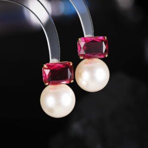 Emerald cut CZ freshwater pearl drop earrings featuring a radiant-cut cubic zirconia stud above a round freshwater pearl with 925 sterling silver ear posts