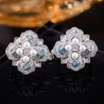 Vintage enamel pearl flower stud earrings featuring a four-petal clover motif set with central pearls, micro-pavé CZ halo, rich enamel accents, and 925 sterling silver posts