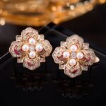 Vintage enamel pearl flower stud earrings featuring a four-petal clover motif set with central pearls, micro-pavé CZ halo, rich enamel accents, and 925 sterling silver posts