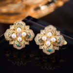 Vintage enamel pearl flower stud earrings featuring a four-petal clover motif set with central pearls, micro-pavé CZ halo, rich enamel accents, and 925 sterling silver posts