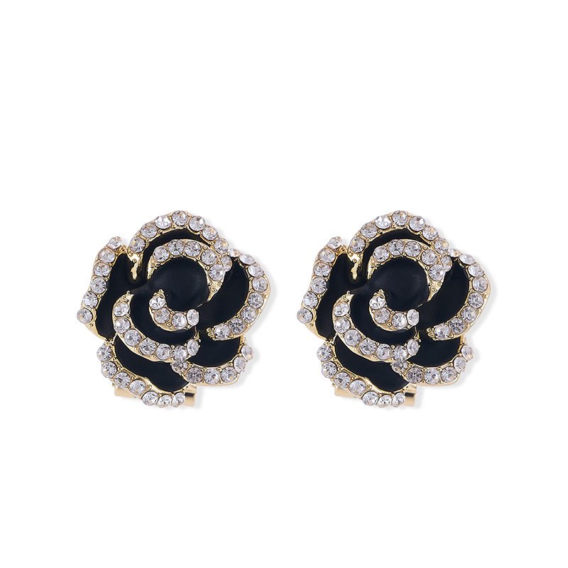 Layered enamel rose clip-on stud earrings featuring clear rhinestone-rimmed petals in rich red and classic black enamel finishes.