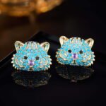 Tiger head CZ turquoise stud earrings featuring micro-pave cubic zirconia tiger motif with 925 sterling silver posts available on junejewelry.com