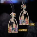 Whimsical fairytale castle arch drop earrings featuring firework star stud topper, pavé frame, and colorful CZ geometric crystal castle towers.