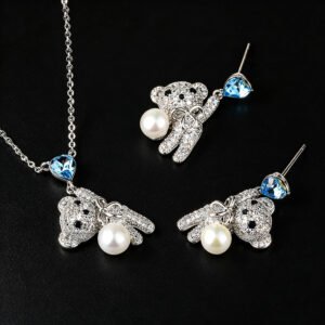 Wholesale pearl bear jewelry set featuring platinum plated copper with blue heart Swarovski element crystals and white pearls from JuneJewelry.com.