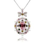 Swarovski crystal bow pendant wholesale featuring palladium plated brass chain, ornate ribbon bow, pearl cluster frame, and oval gemstone, SKU G100898E.