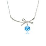 Swarovski crystal bow necklace wholesale with palladium plated brass chain, fluid metal ribbon pendant, and dangling geometric cube crystal, SKU G100907E.