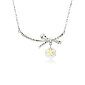 Swarovski crystal bow necklace wholesale with palladium plated brass chain, fluid metal ribbon pendant, and dangling geometric cube crystal, SKU G100907E.
