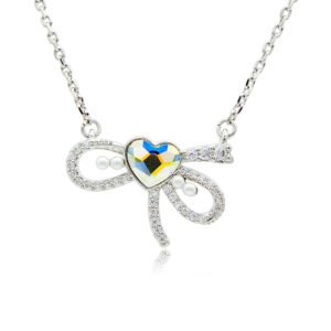 Swarovski crystal heart bow necklace wholesale made with palladium plated brass chain, pave cz bowknot, dainty pearl accents, and heart crystal, SKU G101034E.