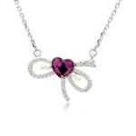 Swarovski crystal heart bow necklace wholesale made with palladium plated brass chain, pave cz bowknot, dainty pearl accents, and heart crystal, SKU G101034E.