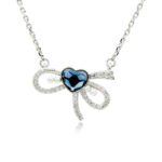 Swarovski crystal heart bow necklace wholesale made with palladium plated brass chain, pave cz bowknot, dainty pearl accents, and heart crystal, SKU G101034E.
