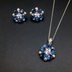 Wholesale floral crystal jewelry set featuring platinum plated copper with fuchsia pink Swarovski element crystals from JuneJewelry.com.