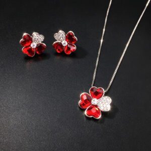 Wholesale clover flower jewelry set featuring platinum plated copper with ruby red heart Swarovski element crystals and pave zirconia petal from JuneJewelry.com.