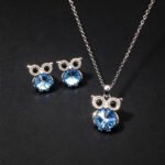 Wholesale owl crystal jewelry set featuring platinum plated copper with blue Swarovski element crystal body and pave zirconia eyes from JuneJewelry.com.