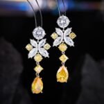 Tear drop CZ floral dangle earrings featuring multi-shaped geometric cubic zirconia, a teardrop crystal pendant, and 925 sterling silver posts