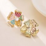 Statement 3D curved flower stud earrings fully encrusted with micro-pave cubic zirconia crystals, available in multicolor, lavender purple, and classic clear silver options.