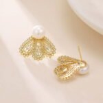 Filigree fan freshwater pearl earrings featuring intricate openwork lace design, central cubic zirconia accents, lustrous cultured pearl stud, and 925 sterling silver ear posts