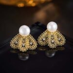 Filigree fan freshwater pearl earrings featuring intricate openwork lace design, central cubic zirconia accents, lustrous cultured pearl stud, and 925 sterling silver ear posts