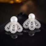 Filigree fan freshwater pearl earrings featuring intricate openwork lace design, central cubic zirconia accents, lustrous cultured pearl stud, and 925 sterling silver ear posts