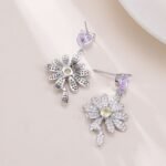 Heart CZ flower drop earrings featuring a heart-cut top gem, micro-paved cubic zirconia flower blossom dangle, yellow center stone, and 925 sterling silver ear posts
