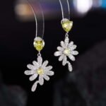 Heart CZ flower drop earrings featuring a heart-cut top gem, micro-paved cubic zirconia flower blossom dangle, yellow center stone, and 925 sterling silver ear posts