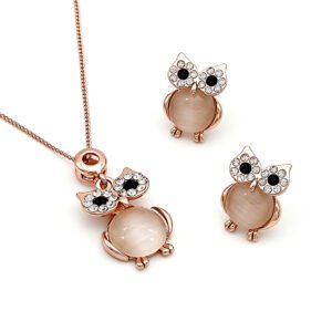 Wholesale crystal owl jewelry set in rose gold plated zinc alloy featuring round cabochon cat eye stone body and pave crystal halo eyes pendant necklace and stud earrings from JuneJewelry.com.