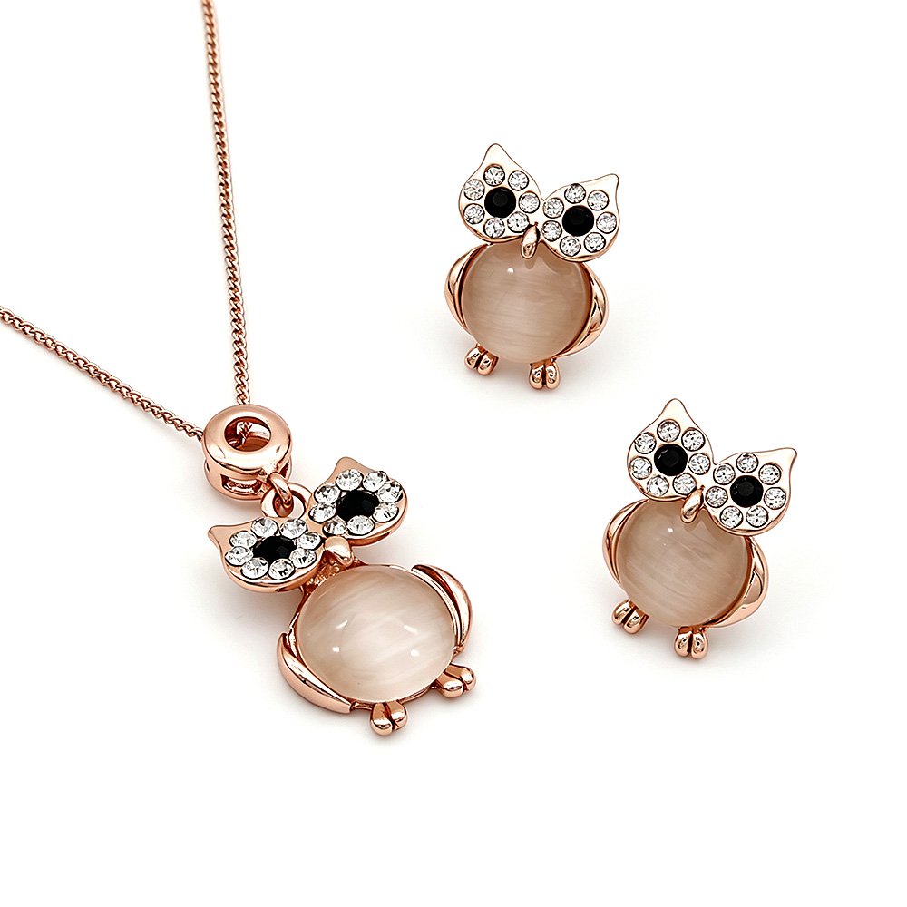 Wholesale crystal owl jewelry set in rose gold plated zinc alloy featuring round cabochon cat eye stone body and pave crystal halo eyes pendant necklace and stud earrings from JuneJewelry.com.