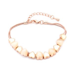 Wholesale heart shell bracelet in rose gold plated zinc alloy featuring heart-shaped cat eye stones and shell beads from JuneJewelry.com.