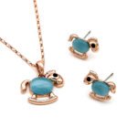 Wholesale rocking horse jewelry set in rose gold plated zinc alloy featuring cat eye stone body pendant necklace and matching stud earrings from JuneJewelry.com.